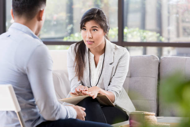 istock Serious counselor talks with male patient 1281125900
