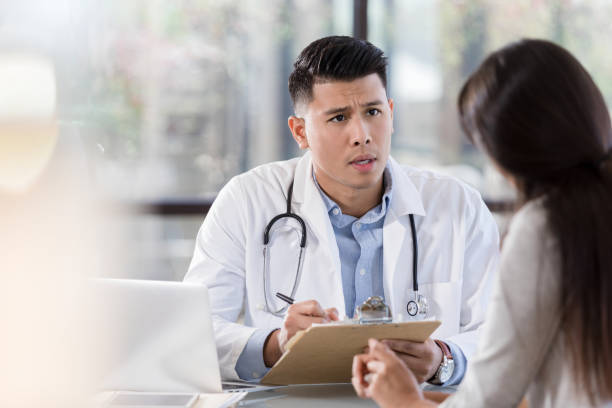 istock Serious doctor discusses patient's diagnosis 1281125932