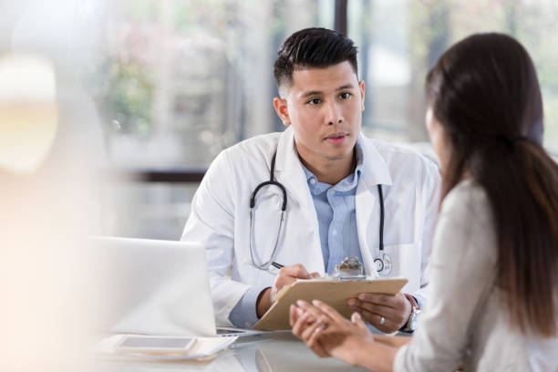 istock Serious doctor talks with patient 1281125939
