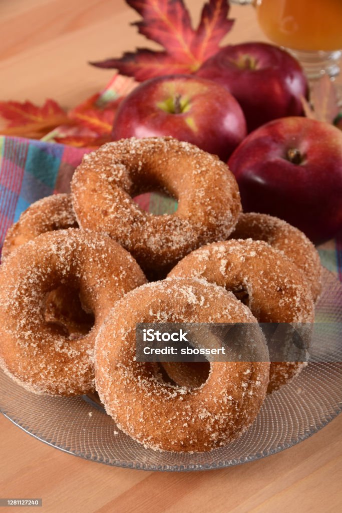 Fresh New England Apple Cider Doughnuts A traditional New England autumn treat - freshly made apple cider donuts rolled in sugar, served with a mug of hot apple cider. Doughnut Stock Photo