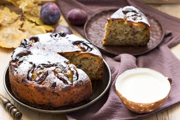 istock Plum pie with nuts and chocolate on a wooden background. Rustic style. 1281127429