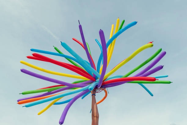 istock Hand holding colorful balloons on a LGBT parade Selective focus 1281127678