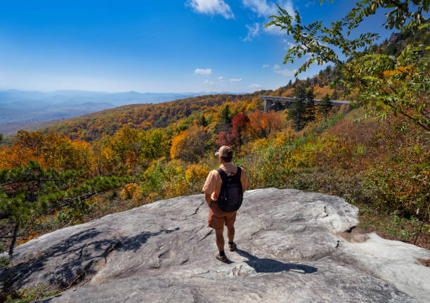 istock Man looking at beautiful mountain view on autumn hiking trip. 1281128444