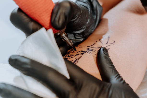 istock Tattoo artist doing her job 1281128632