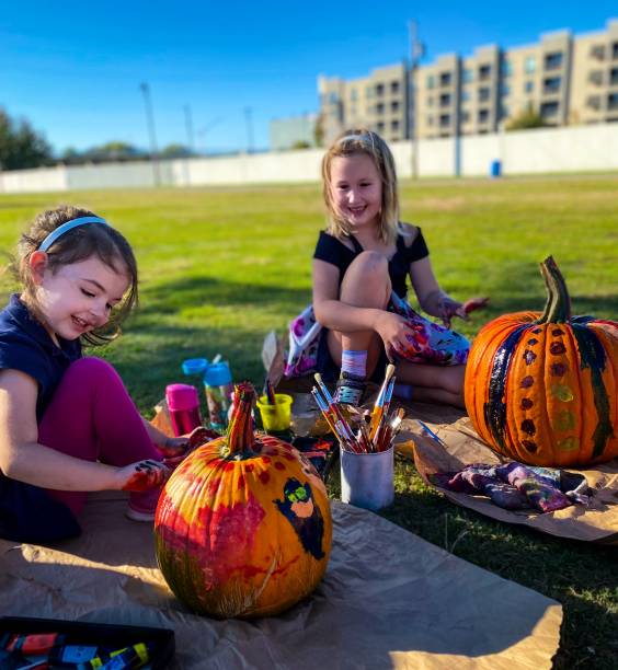 istock Painting Pumpkins in the Park 1281130352