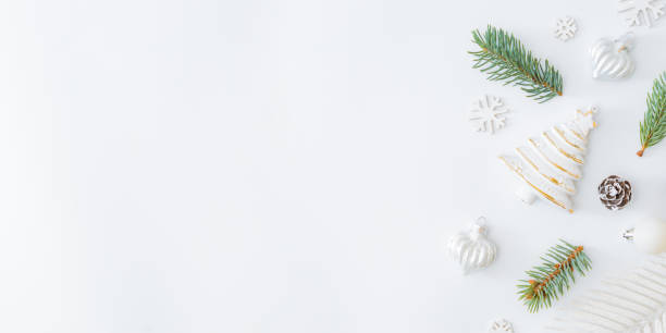istock Flat lay frame with fir branches and christmas baubles decoration on a white background 1281131981