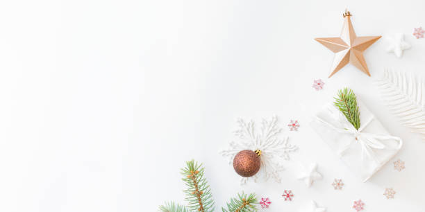 istock Flat lay frame with fir branches, christmas baubles decoration and gift box on a white background 1281131986