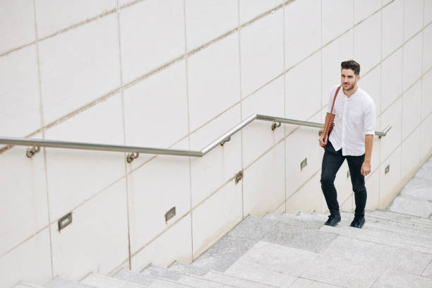 istock Businessman walking up the stairs 1281133322
