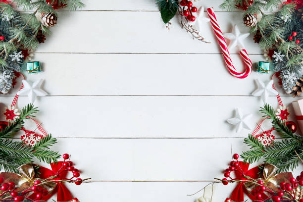 istock Beautiful Christmas composition on white background with Christmas gift boxes, snowy fir branches, conifer cones, holiday decoration, caramel stick and red berry. Top view, copy space. 1281136251