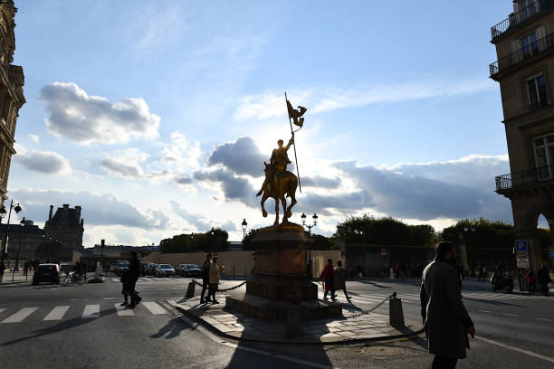 The Place des Pyramides, Paris, France. Paris, France-10 18 2020:People passing by the equestrian statue of the French heroine Joan of Arc (1412 - 1431), which is prominently located in the Place des Pyramides in Paris, France. place des pyramides stock pictures, royalty-free photos & images
