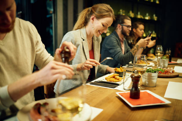 istock Group of friends sitting in restaurant and having dinner. 1281137178