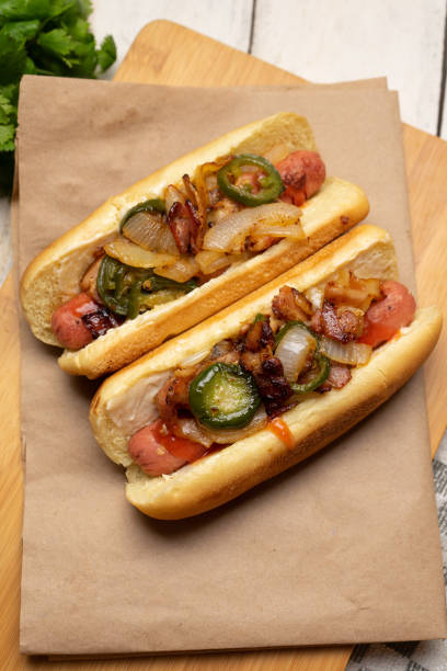 istock Hot dog with jalapeno pepper, bacon and caramelized onion on white background 1281140958