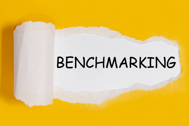 istock Text Benchmarking appearing behind torn yellow paper 1281141007