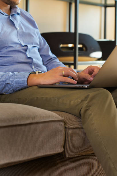 istock Young millennial businessman, freelancer working from home on the couch 1281141121