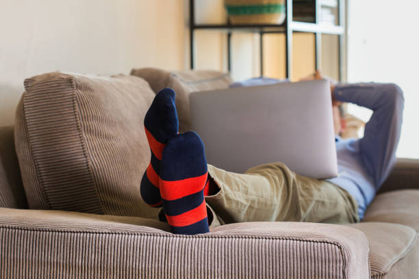 istock Young millennial businessman, freelancer working from home on the couch 1281141143
