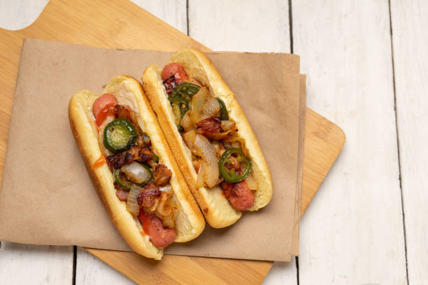 istock Hot dog with jalapeno pepper, bacon and caramelized onion on white background 1281141832