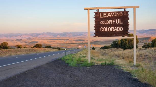 istock Leaving Colorful Colorado sign at dusk 1281144104