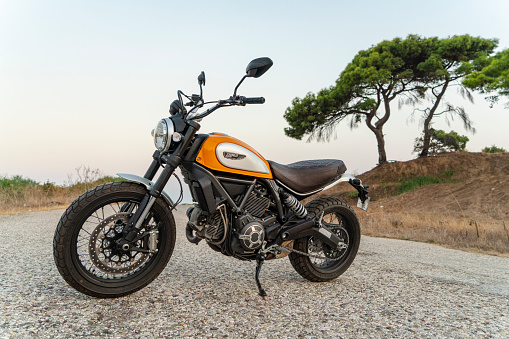 Antalya, Turkey - September 10, 2016: Ducati Scrambler Icon parked near a country road in Antalya, Turkey. The motorcycle is propelled by an L-twin, Desmodromic, 2 valves per cylinder, air cooled engine with a displacement of 803 cc which delivers a maximum power of 55 KW (75 Hp) at 8,250 Rpm and 68 Nm (50 Lb-Ft) of torque at 5,750 Rpm. The new model of Ducati Scrambler was introduced at the 2014 Intermot motorcycle show. Ducati is an Italian company that designs and manufactures motorcycles