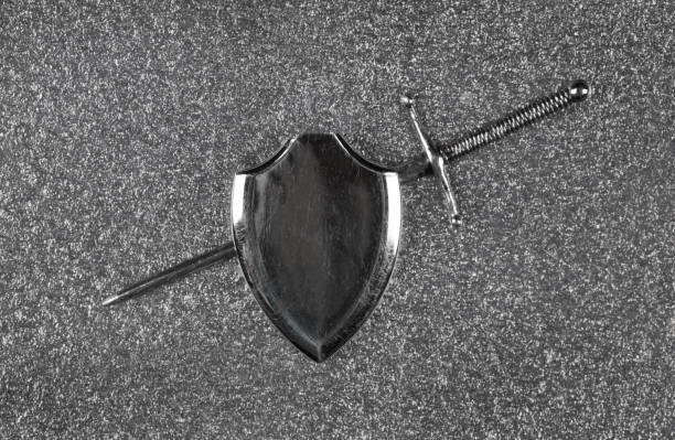medieval sword and shield isolated on gray metal background