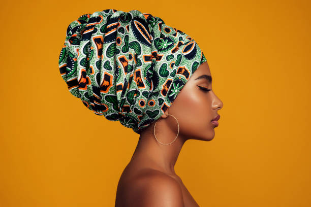 African woman with a colorful shawl on her head African woman with a colorful shawl on her head black shawl wrap stock pictures, royalty-free photos & images