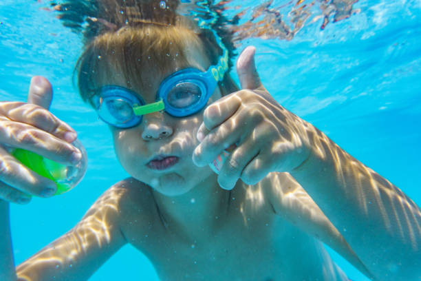 istock Little boy diving in swimming pool 1281149061