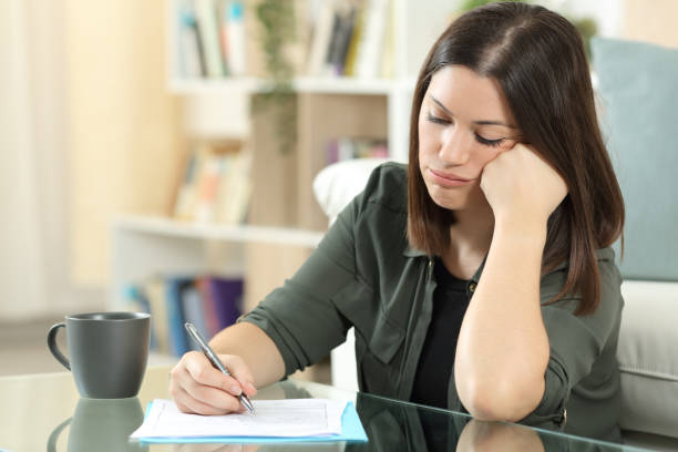 istock Frustrated woman filling form at home 1281149897