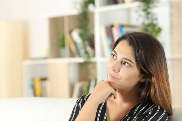 istock Thoughtful woman looking at side at home 1281149932