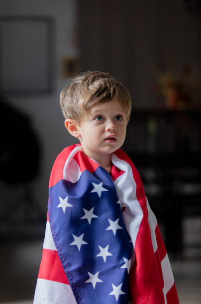 istock Little kid play with USA flag at home alone 1281152789