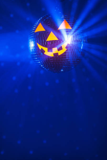 istock Halloween party pumpkin disco ball, blue shiny rays background 1281152876
