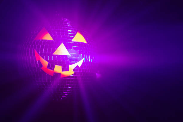 istock Halloween party pumpkin disco ball, jack o'lantern with shiny rays in smoke 1281152900