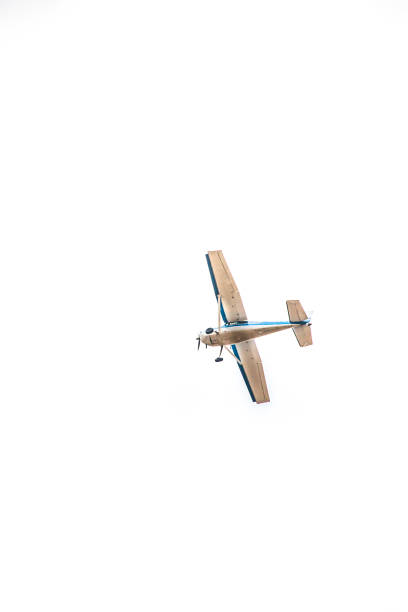 a picture of a Blue and White airplane flying in a white sky