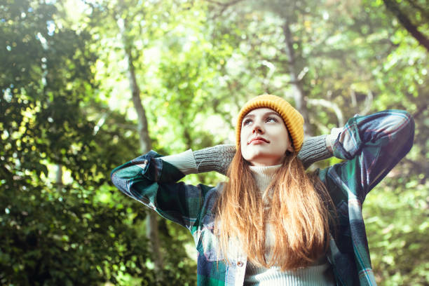 istock Young woman enjoying nature in green forest 1281156048