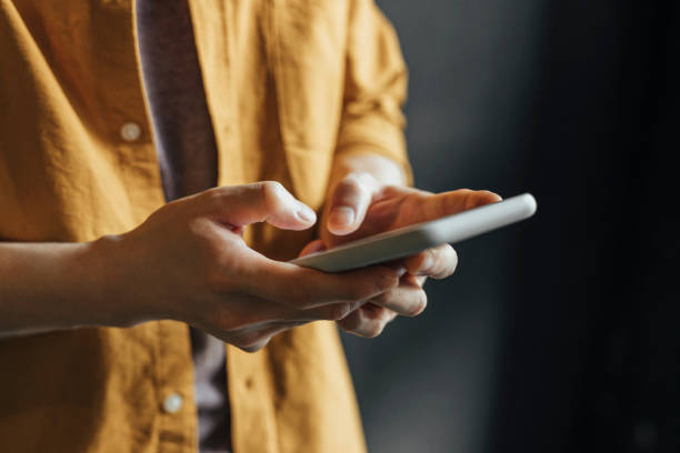 istock Anonymous Man Wearing a Yellow Shirt Using Modern Technology, a Close Up 1281156877