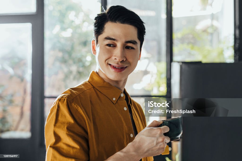 Happy Asian Man Sipping Hot Tea For Breakfast At Home Stock Photo ...