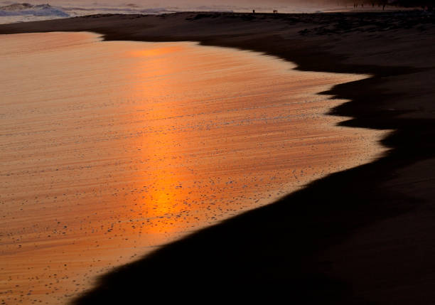 Sunset reflection at Tanjung Aru beach, Sabah, Malaysia