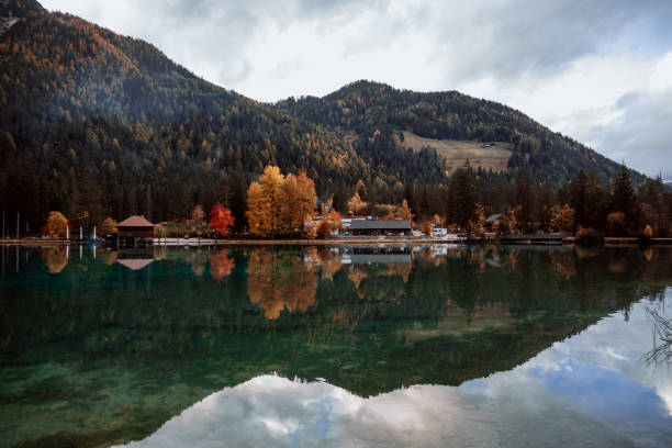 istock Reflection of mountain and trees on lake in dolomite 1281160401