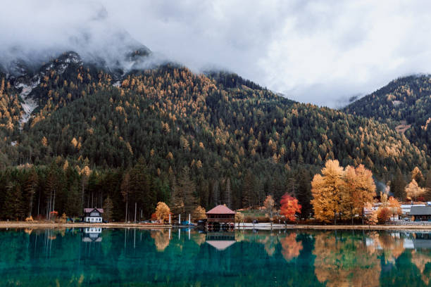istock Reflection of mountain and trees on lake in dolomite 1281160402