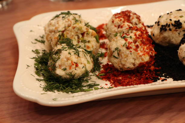 istock delicious cheese balls on white plate on wooden table 1281167320