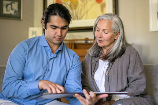 a senior woman meets with a financial advisor - lawyer family talking discussion imagens e fotografias de stock