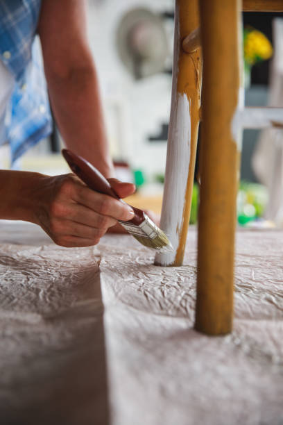istock The hand of dedication while decorating an old chair 1281173031