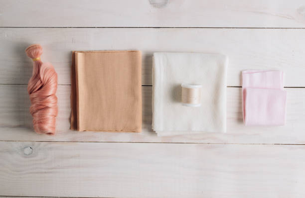 istock Textile doll in the sewing process with accessories and materials on white wooden background 1281176517