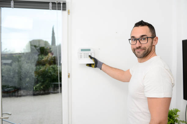 istock handsome man worker installing alarm technology insurance in home for burglar prevention 1281177123