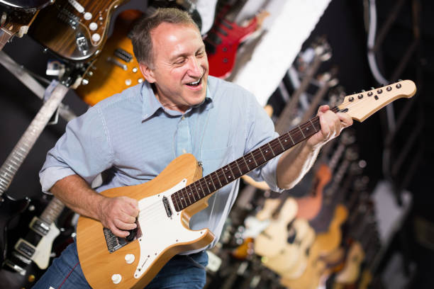 istock Male is playing on  electric guitar in music studio 1281177558
