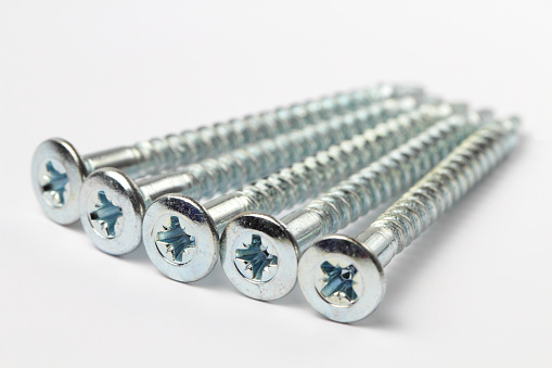 Screws for dowels close-up on a white background.
