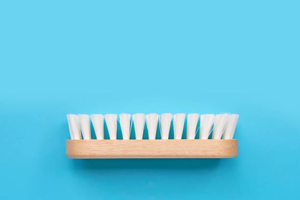 istock Wooden clothes brush on blue background. 1281179376