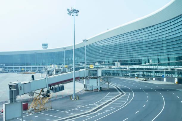 istock Internal road, passenger boarding bridge and airport terminal 1281181857