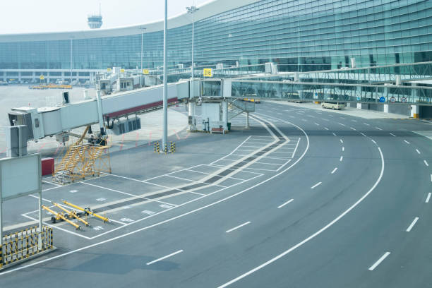istock Internal road, passenger boarding bridge and airport terminal 1281181871