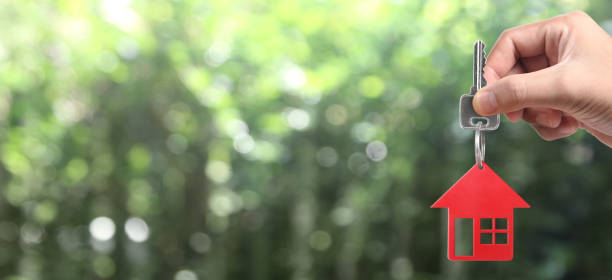 istock Real estate agent handing over house keys 1281184309