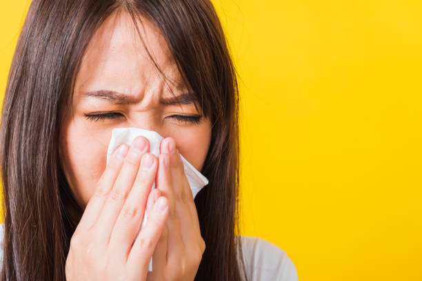 istock Woman sneezing sinus using towel to wipe snot from nose 1281192208
