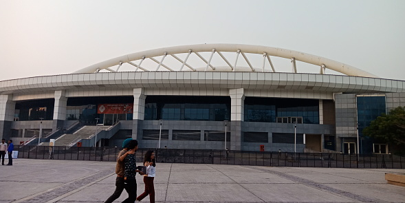 CITY DELHI, INDIA - JANUARY 25, 2020: Thyagaraj Sport Complex Building view on road side sky background.